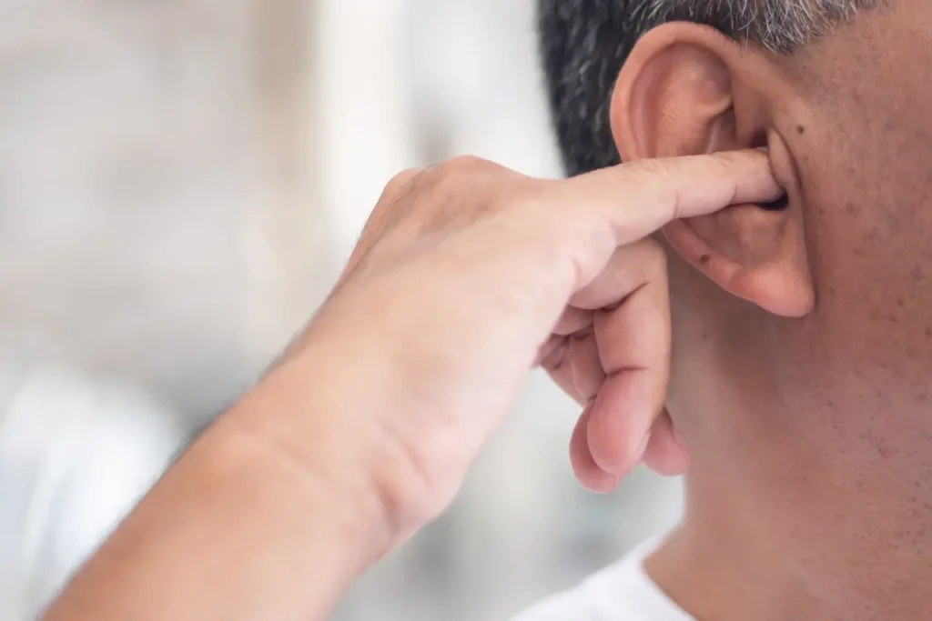 Man picking his ear