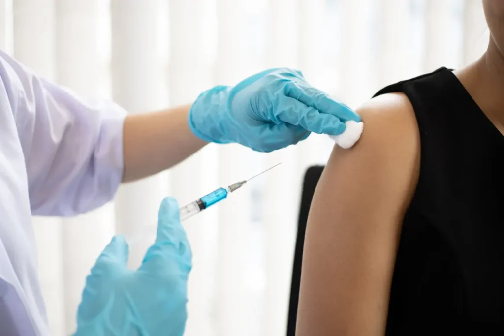 Doctor vaccinating against new strains of the virus for the patient